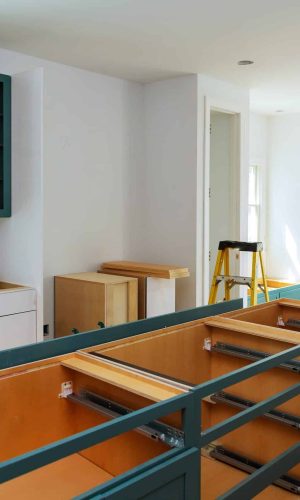 Custom kitchen cabinets in various stages of installation base for island in center Installation of kitchen cabinets