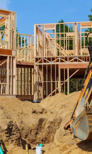 Unfinished house of still under construction. Building concept The excavator digs new building